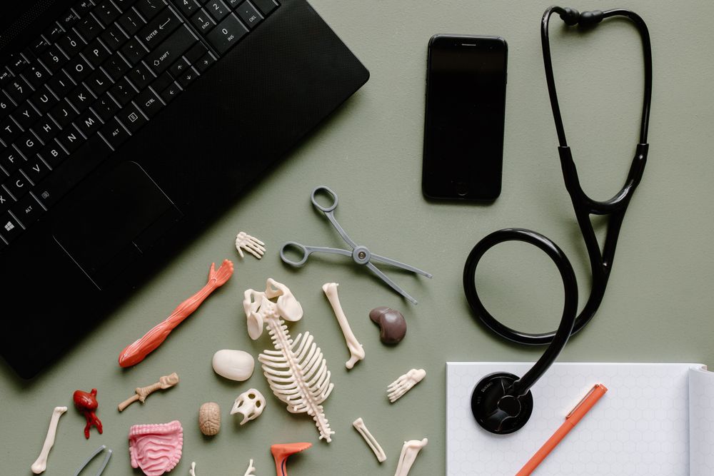 Medical tools and a laptop arranged on a work surface